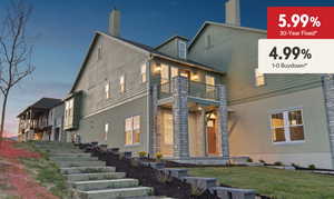 Back of property at dusk featuring a balcony, a chimney, and stucco siding