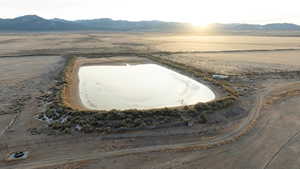 Aerial view featuring a rural view, a mountain view, and view of desert