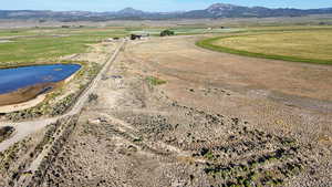 Aerial overview of property's location featuring rural landscape and a water and mountain view
