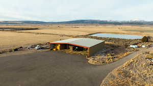 Birds eye view of property with a water and mountain view and a rural view