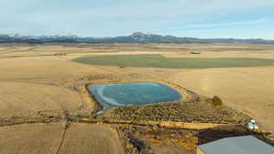 Bird's eye view with view of golf course and a mountain view