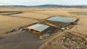 Aerial view featuring view of desert, a mountain view, and a rural view