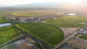 Aerial view of property's location with rural landscape and a mountain backdrop