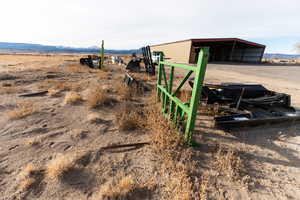 View of yard with a mountain view, an outbuilding, and a rural view
