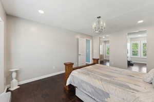 Bedroom with baseboards, recessed lighting, a chandelier, and hardwood / wood-style flooring