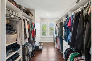 Spacious closet featuring dark wood-type flooring