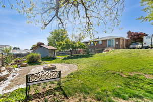View of yard featuring a fenced backyard and an outdoor fire pit