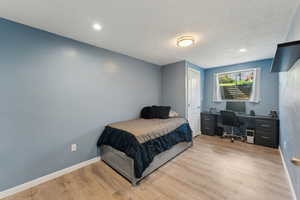 Bedroom featuring baseboards, recessed lighting, and wood finished floors