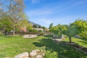 View of yard featuring a patio, a fenced backyard, and a mountain view