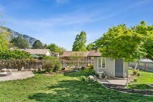 View of yard with a mountain view and a fenced backyard