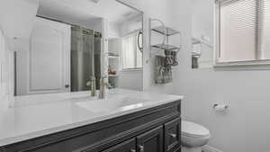 Full bathroom featuring toilet, a shower with curtain, and a wealth of natural light