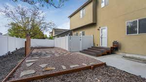 View of yard featuring a fenced backyard, a patio area, and a gate