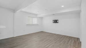 Empty room with recessed lighting, baseboards, and wood finished floors