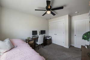 Bedroom featuring ceiling fan, carpet floors, baseboards, visible vents, and a closet