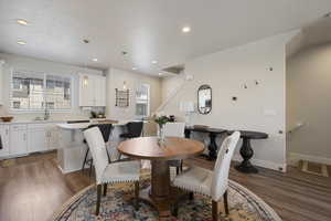 Dining space with recessed lighting, wood finished floors, and a wealth of natural light