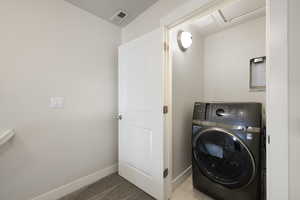 Laundry area with baseboards, laundry area, washer / clothes dryer, and visible vents
