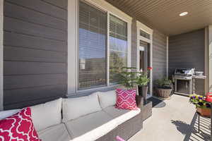 View of patio / terrace with a porch, an outdoor living space, and a grill