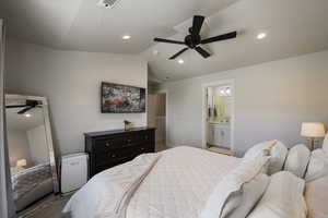 Bedroom with lofted ceiling, recessed lighting, ensuite bath, and visible vents