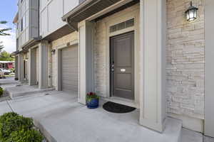 Entrance to property with a garage and board and batten siding