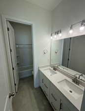 Full bathroom with tile patterned flooring, a sink, and double vanity