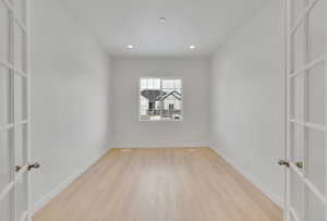 Spare room with recessed lighting, baseboards, french doors, and light wood finished floors
