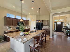 Elegant kitchen with spacious island, great room open floor plan flooded with natural light. 10' ceilings make the space feel open and grand.