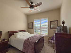2nd bedroom on the main floor with a large window and beautiful view of the yard and mountains.