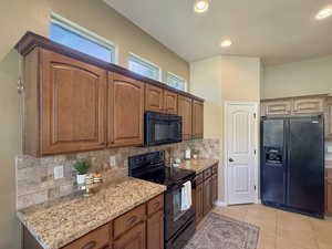 Elegant kitchen with spacious island, great room open floor plan flooded with natural light.