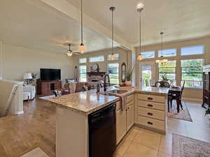 Elegant kitchen with spacious island and flooded with nautural light. Great room open floor plan with kitchen, dining, and family room perfect for entertaining. 10' ceilings make the space feel more open and grand.