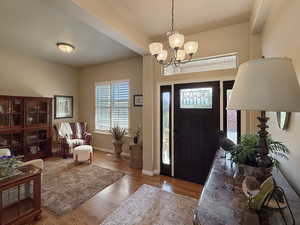 Beautiful foyer entry with attached formal living room and real hardwood floors.
