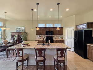 Elegant kitchen with spacious island, great room open floor plan flooded with natural light.