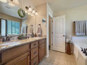 Beautiful primary suite bathroom with soaking tub, shower, and separate water closet.