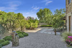 View of yard featuring a fenced backyard, a patio area, and a mountain view