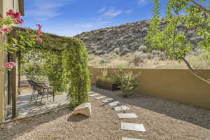 View of yard featuring a patio, a mountain view, and fence