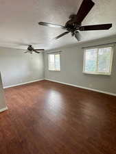 Unfurnished room with a ceiling fan, a textured ceiling, and wood finished floors