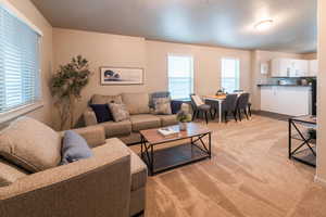Living room featuring light carpet