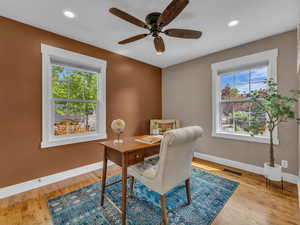 Office with a ceiling fan, baseboards, visible vents, and plenty of natural light