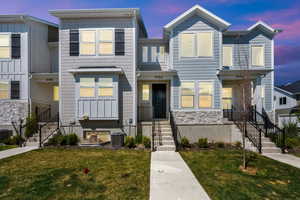 Multi unit property with a yard, central AC, stairway, and stone siding