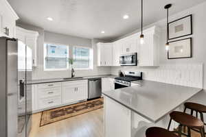 Kitchen with recessed lighting, a sink, a peninsula, and stainless steel appliances