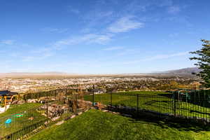 View of yard featuring fence and a mountain view