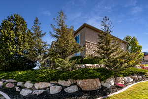 View of home's exterior featuring stucco siding and stone siding