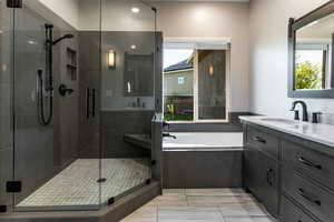 Bathroom featuring vanity, a stall shower, recessed lighting, and a bath