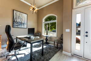 Office featuring crown molding, baseboards, and an inviting chandelier