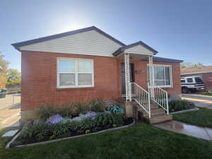 Bungalow-style home with brick siding