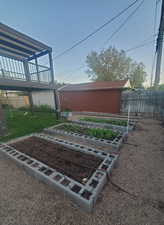 View of yard with fence, a garden, and a playground