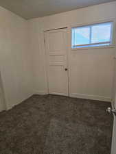 Empty room with baseboards and carpet