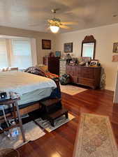Bedroom featuring baseboards, a ceiling fan, and wood finished floors