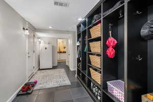Mudroom featuring dark tile patterned flooring, recessed lighting, and visible vents