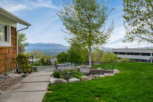 View of yard with fence and a mountain view