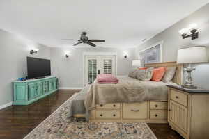 Bedroom with baseboards, access to outside, a ceiling fan, and dark wood-type flooring